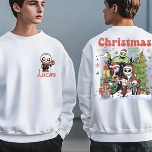 A white sweatshirt with a Christmas-themed design featuring characters from the movie " jack Skellington".