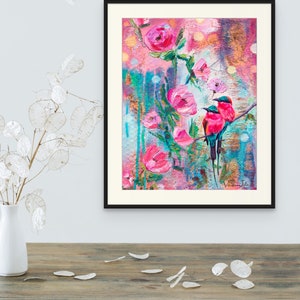 May include: A painting of two pink birds perched on a branch with pink flowers. The background is a colorful abstract design with splashes of blue, green, and gold.
