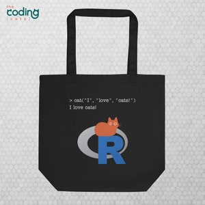 May include: Black tote bag featuring a white cat sitting on the letter 'R' within a blue circle. The bag displays the text 'coding {cats}' and 'cat("I", "love", "cats!")' in white. The phrase 'I love cats!' is also printed in white.