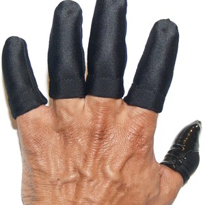 May include: A hand with black finger protectors on four fingers and a black thumb protector. The protectors are made of a smooth, shiny material. The hand is against a white background.