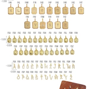 May include: Gold-toned initial pendants with clear crystal accents. The pendants are available in various letter designs, with rectangular and circular shapes. The image also shows the brand name "TRENDTASTIC".