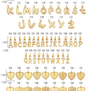 May include: Gold-colored alphabet charms and heart-shaped pendants. The image displays various letter charms, each approximately 0.5 inches tall, and heart pendants with letters. The brand name "TRENDTASTIC" is at the top.