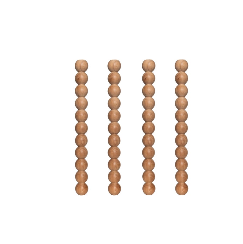 May include: Four wooden bead strands, each with 15 beads, hanging vertically against a white background.