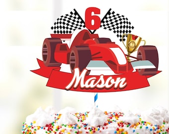 May include: A red race car cake topper with a checkered flag and the number 6. The topper is on a white cake with colorful sprinkles. The name Mason is written on a red banner below the car.