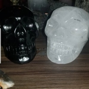Beautiful large black obsidian skull and clear quartz skull carving (2 pieces)