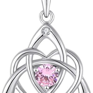 May include: Silver Celtic knot pendant necklace with a pink gemstone in the center and smaller clear gemstones on the sides.
