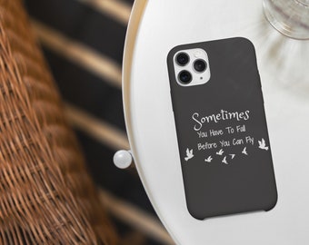 May include: A black phone case with a white quote that reads "Sometimes you have to fall before you can fly" and white silhouettes of birds.