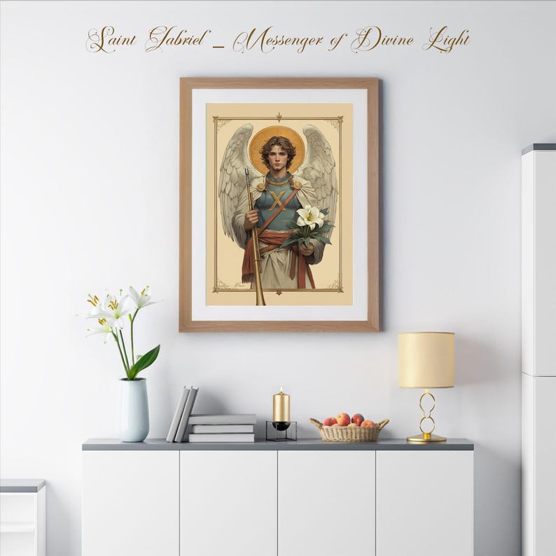 May include: A framed print of a religious painting depicting Saint Gabriel, the messenger of divine light. The painting features a winged angel holding a white lily and a staff. The frame is brown wood with a gold trim.