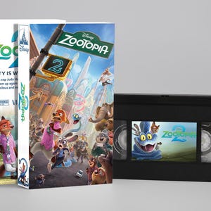 May include: A Zootopia 2 VHS tape and two matching movie cases. The cases feature colourful illustrations of the characters. The VHS tape is black with a colourful label. The cases have the Disney logo.