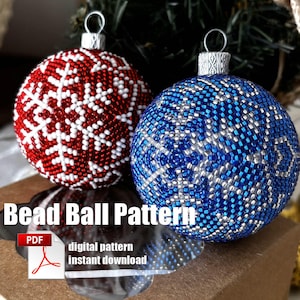 May include: Two beaded Christmas baubles, one red with white snowflakes and one blue with silver snowflakes, in a brown box with the text "Bead Ball Pattern" and "digital pattern instant download".
