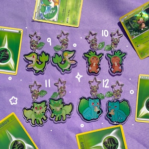 May include: A set of ten green and white Pokemon character keychains. The keychains are made of clear acrylic and feature different Pokemon characters from the Grass-type. The keychains are numbered 9 through 12.