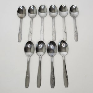 May include: Set of ten silver teaspoons with a star design on the handle.