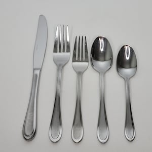 May include: A set of five silver-toned flatware pieces, including a knife, two forks, and two spoons. The flatware has a simple, elegant design with rounded edges.