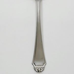 May include: A stainless steel fork with a decorative floral design at the base of the handle. The fork has a polished, reflective surface and a simple, elegant design, suitable for formal dining.