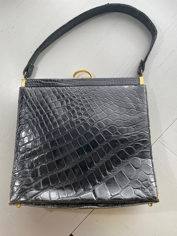 Black leather handbag with brass hardware