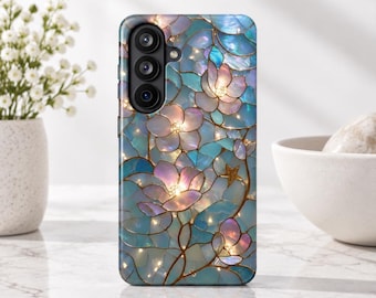 May include: A rectangular smartphone case featuring a stained-glass style pattern of light blue, teal, and soft pink flower petals outlined in gold. The design includes small gold star accents and a triple-lens camera cutout on the upper left side.