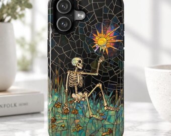 May include: A black phone case featuring a stained glass style design of a skeleton sitting in a field of green and blue grass with small orange flowers. The skeleton reaches up toward a bright, multi-colored sun set against a dark sky.