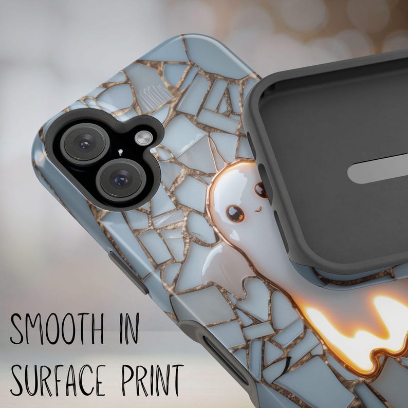 May include: A phone case featuring a light blue and white mosaic pattern with gold-colored grout lines. A small, white, cartoon-style ghost character with large dark eyes is visible on the surface. The text SMOOTH IN SURFACE PRINT is present.