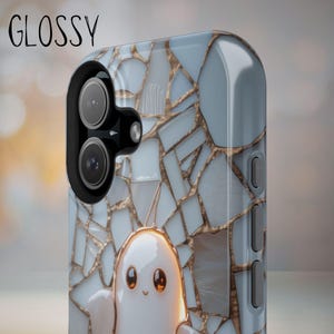 May include: A glossy phone case featuring a light blue and white mosaic tile pattern with gold grout lines. A small, white, rounded ghost-like character with large brown eyes is centered at the bottom. The word GLOSSY is printed in black.