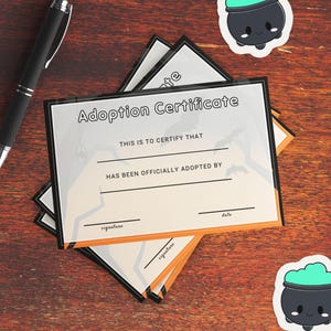 A close up photo of the printed Halloween themed adoption certificate. Bring a pen to have ready for your market clients, or mail a certificate with your purchased plushies!