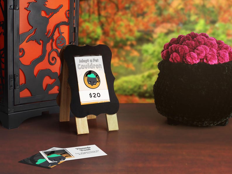 A market display example showing a table with the market sign and price, thank you cards, and cauldrons!