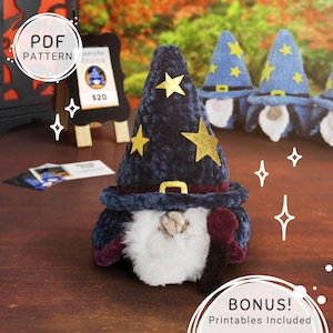May include: A plush wizard gnome with a navy blue hat adorned with gold stars and a matching belt buckle. The gnome has a white beard, a burgundy cloak, and a black staff. Additional wizard gnomes are in the background.