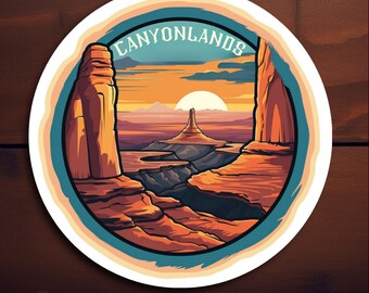 May include: A colorful sticker featuring a scenic view of Canyonlands National Park in Utah. The sticker features a sunset over a canyon with red rock formations and the text "Canyonlands" in a blue and white font.