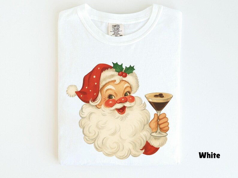 May include: White t-shirt featuring a vintage illustration of Santa Claus holding a cocktail. Santa is depicted with a red hat, white beard, and rosy cheeks. The cocktail has coffee beans on top. The word "White" is printed on the bottom right.