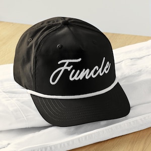 May include: A black baseball cap with a white rope trim and the word "Funcle" embroidered in white on the front.
