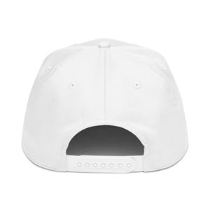 May include: A white baseball cap with a curved brim and adjustable snapback closure. The cap features a structured crown with six panels and a button on top. The back of the cap has a white strap with multiple adjustment holes.