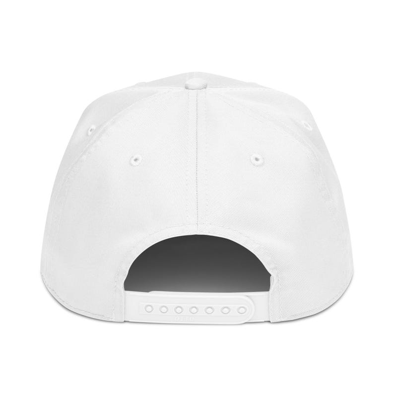 May include: A white baseball cap with a curved brim and adjustable snapback closure. The cap features a structured crown with six panels and a button on top. The back of the cap has a white strap with multiple adjustment holes.