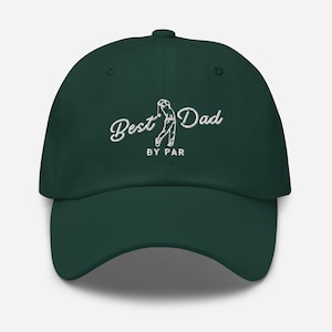 May include: A dark green baseball cap with white embroidery that reads "Best Dad By Par" and features a golfer in the middle of a swing.
