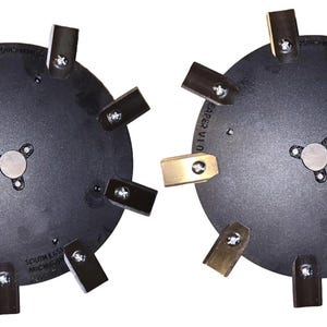 May include: Two black metal circular saw blades with eight blades each. The blades are made of metal and have a black finish. The blades are attached to a black metal hub. The blades are labeled "SAFE 2  VID" and "SOUTH 1  MIC"