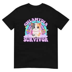 May include: Black t-shirt with a rainbow and a cartoon cat. The text "Chlamydia Survivor" is written in a purple retro font.