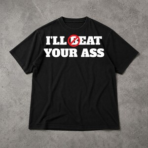 May include: Black t-shirt with the text "I'LL BEAT YOUR ASS" in white, with a red circle and line through the word "BEAT". The shirt has short sleeves and a crew neck.