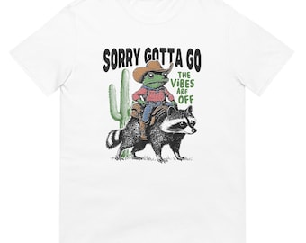 Cowboy Frog Riding Raccoon Shirt, Whimsical Animal Western Graphic Tee for Nature Lovers, Fun Gift for Outdoors Enthusiasts