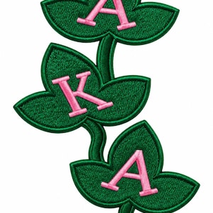 May include: An embroidered patch featuring three dark green ivy leaves connected by stems. Each leaf contains a light pink letter, spelling out A, K, and A from top to bottom. The edges of the leaves and the letters are stitched with a raised border.