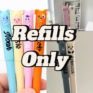 May include: A selection of colourful pens featuring animal-themed designs, such as an elephant, sheep, cat, dog, bear, and panda. Each pen is inscribed with a name. The text "Refills Only" is also displayed.