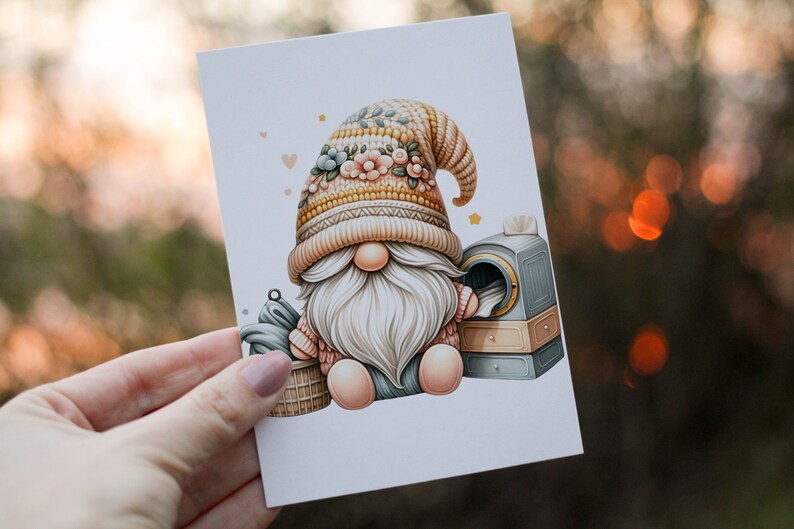 May include: A gnome wearing a knitted hat with floral accents sits next to a small laundry machine. The gnome is holding a basket of clothes.