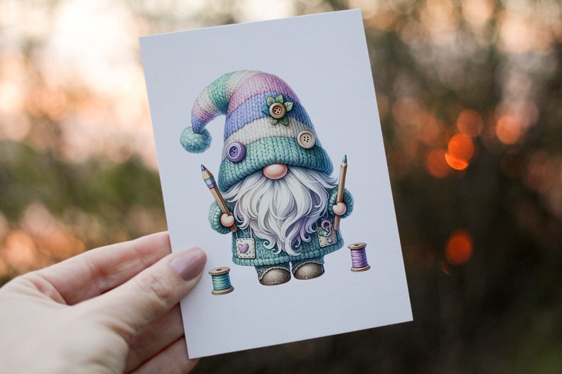 May include: A whimsical gnome illustration with a blue, green, and pink knitted hat, holding two pencils and surrounded by spools of thread.