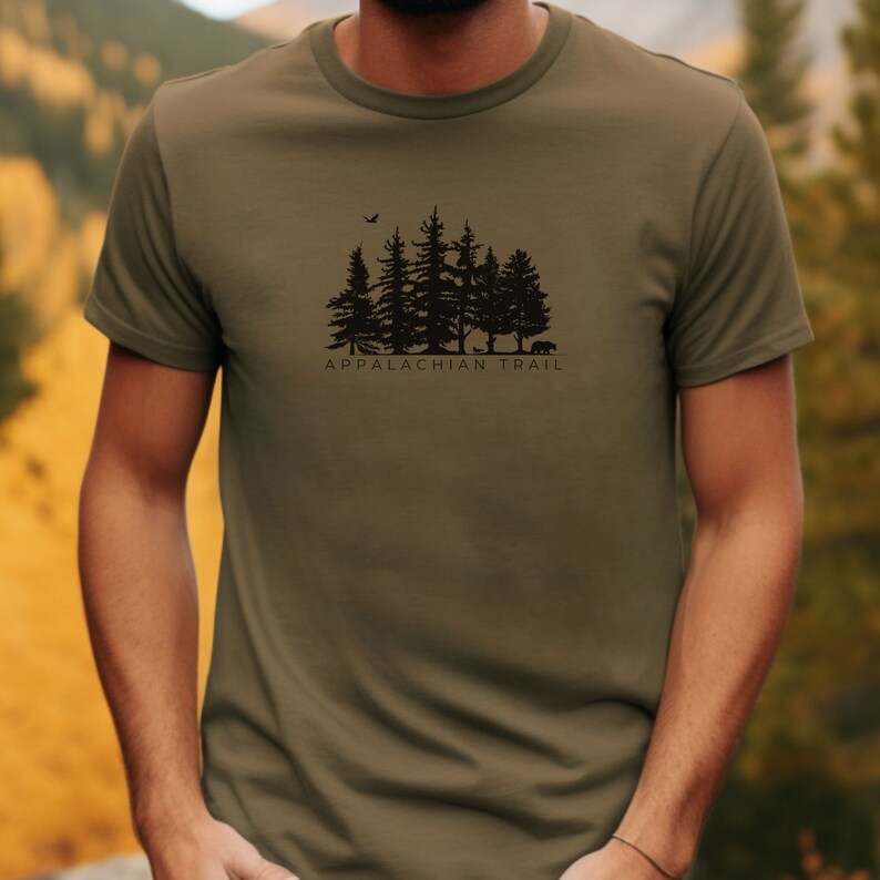 May include: A green t-shirt featuring a black silhouette of a forest and the text "Appalachian Trail".