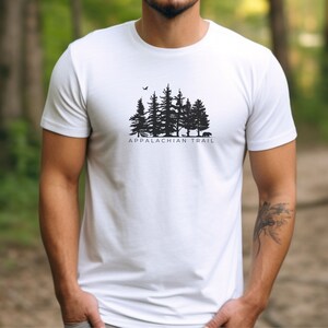 May include: White t-shirt with a black silhouette of a forest and the text "Appalachian Trail".