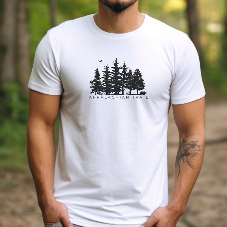 May include: White t-shirt with a black silhouette of a forest and the text "Appalachian Trail".