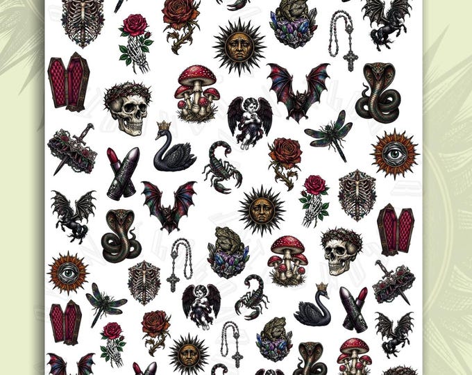 Gothic-style water-slide nail art decals featuring skulls, snakes, suns, and eyes
