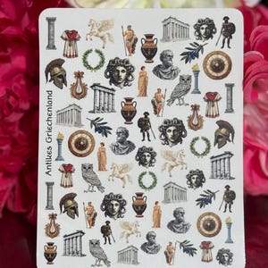 Può includere: Un foglio di adesivi rettangolare che presenta una collezione di piccole illustrazioni dettagliate di motivi greci antichi, tra cui colonne, elmi, vasi, gufi, corone d'alloro, statue e figure mitologiche, con il testo Antikes Griechenland.