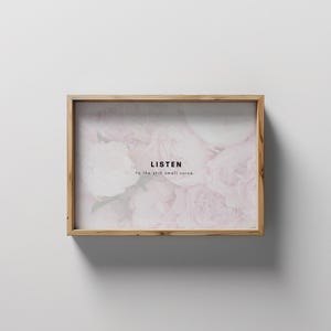 May include: A framed print with a floral design in shades of pink and white. The text "LISTEN to the still small voice." is printed on the image.