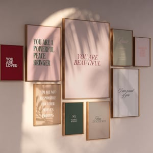 May include: A wall gallery featuring eight framed prints with inspirational messages in various colors, including pink, green, and red. The prints feature phrases like "You are loved", "You are a powerful peace bringer", "You are beautiful", and "Focus on your why".