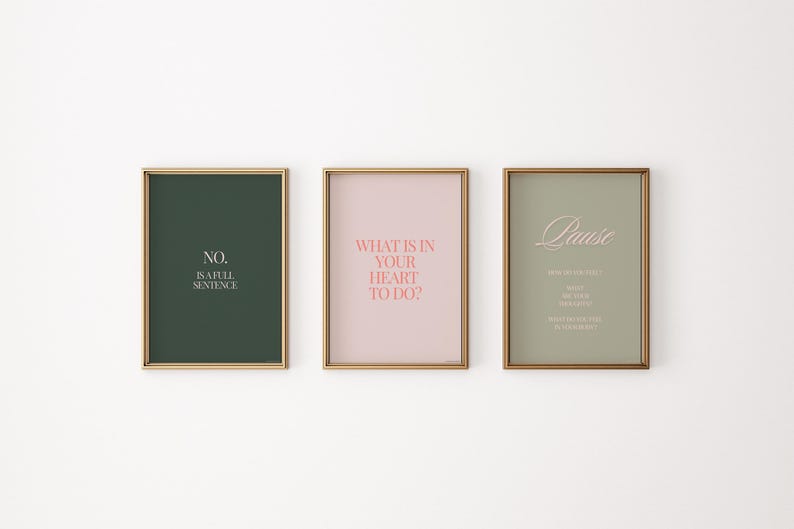May include: Three framed prints with motivational quotes. The first print has a dark green background with the text "NO. is a full sentence." in white. The second print has a light pink background with the text "WHAT IS IN YOUR HEART TO DO?" in pink. The third print has a light green background with the text "Pause" in white and a poem about pausing in white.
