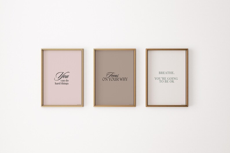 May include: Three framed motivational posters with gold frames. The posters have a light pink, light brown, and white background. The text on the posters reads "You can do hard things", "Focus on your why", and "Breathe. You're going to be ok."