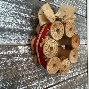 May include: A white ceramic mug with a black handle and the text "But First, Coffee" in a black, bold font. The mug is on a white surface. The mug is approximately 4 inches tall.